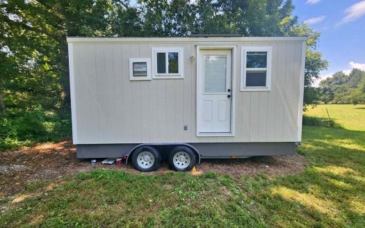 Custom Tiny Home on Wheels with Wood Textured Siding and Dual Axle Trailer in Ooltewah Tennessee