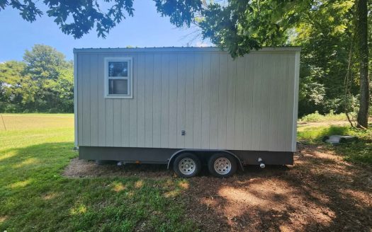 Custom Tiny Home on Wheels with Wood Textured Siding and Dual Axle Trailer in Ooltewah Tennessee