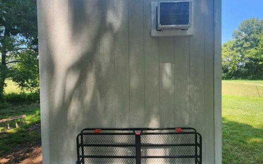 Custom Tiny Home on Wheels with Wood Textured Siding and Dual Axle Trailer in Ooltewah Tennessee